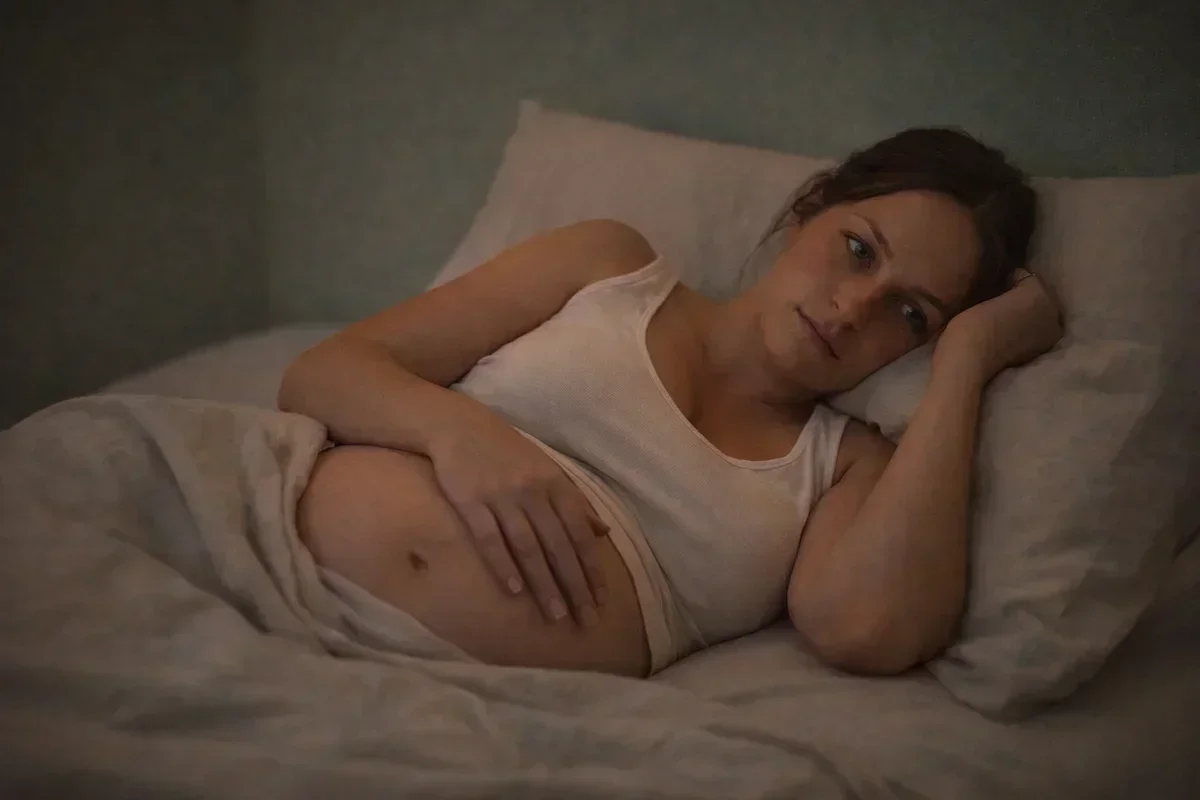 Pregnant woman lying awake in bed during the third trimester unable to sleep